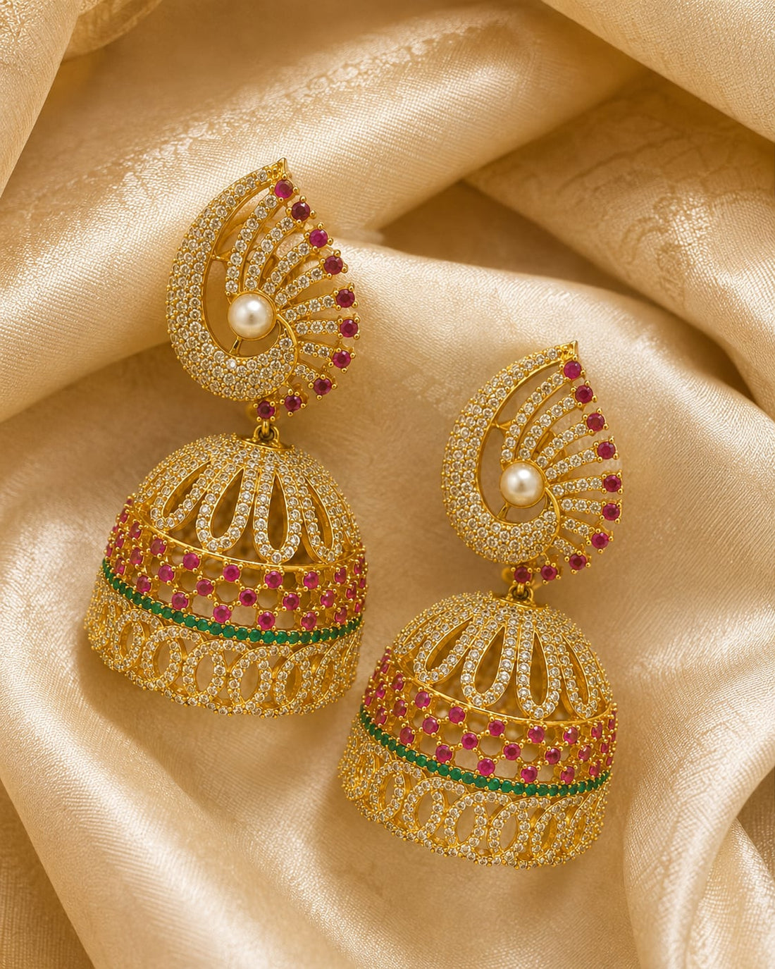 FeelOri gold-plated ruby fan CZ jhumka earrings with pearl-look drops styled with saree fabric