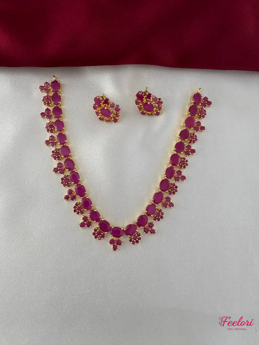 FeelOri Gold Plated Ruby Petal Necklace and Earring Set - Full view showcasing the continuous floral design of the necklace and matching studs.