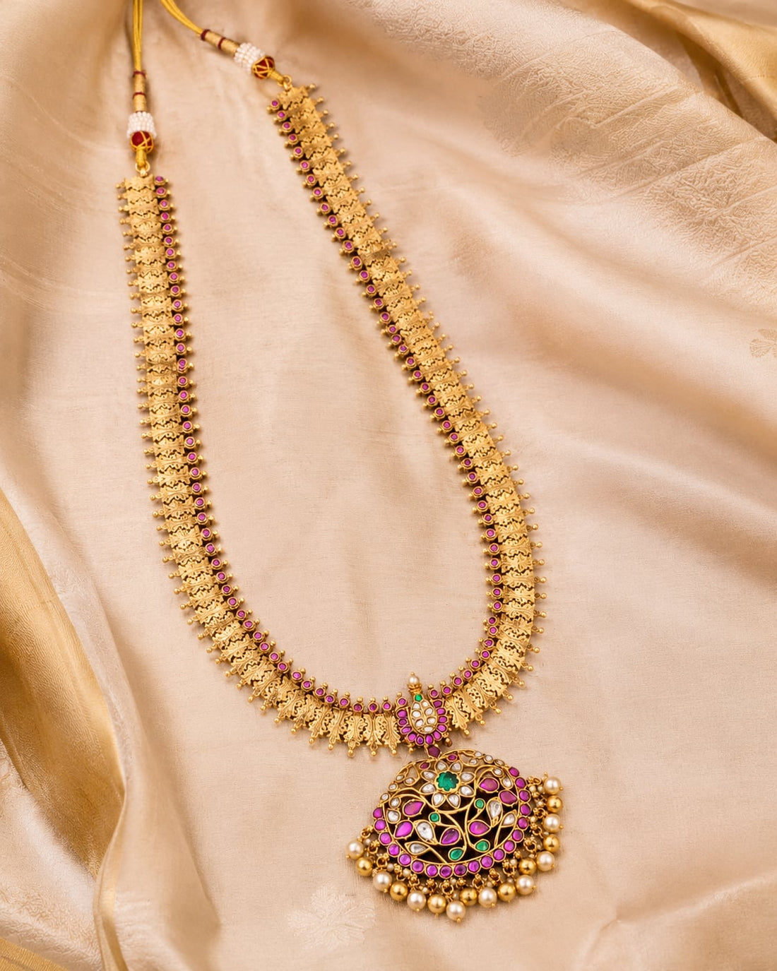 FeelOri gold-polished long haram necklace styled with saree fabric for Indian occasion wear