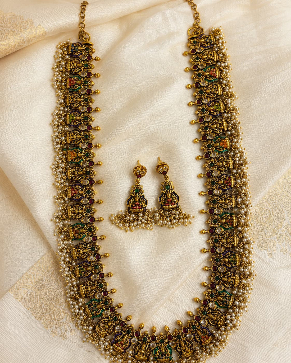 FeelOri gold-polished necklace set with matching earrings styled with saree fabric for Indian occasion wear