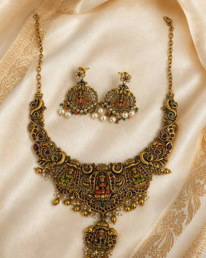 FeelOri gold-polished necklace set with matching earrings styled with saree fabric for Indian occasion wear