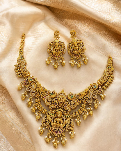 FeelOri gold-polished necklace set with matching earrings styled with saree fabric for Indian occasion wear