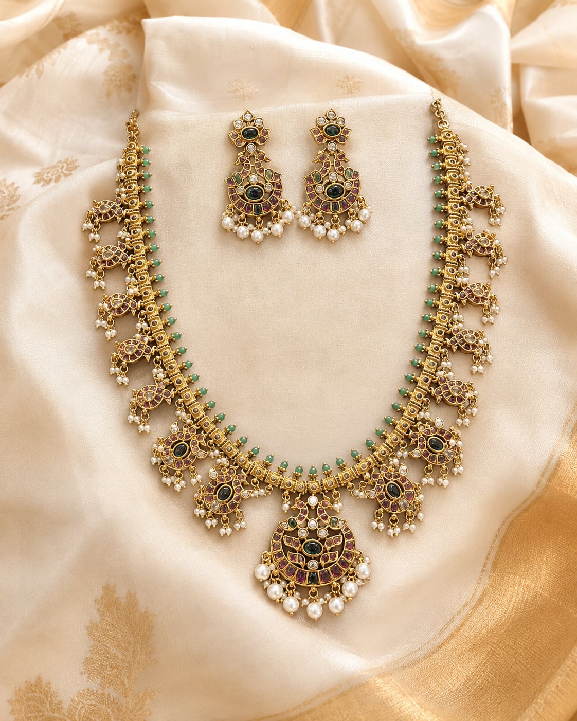 FeelOri gold-polished necklace set with matching earrings styled with saree fabric for Indian occasion wear