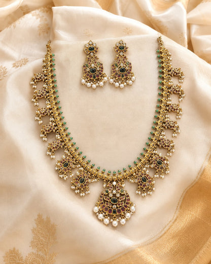 FeelOri gold-polished necklace set with matching earrings styled with saree fabric for Indian occasion wear