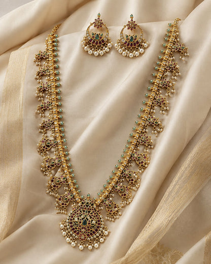 FeelOri gold-polished necklace set with matching earrings styled with saree fabric for Indian occasion wear