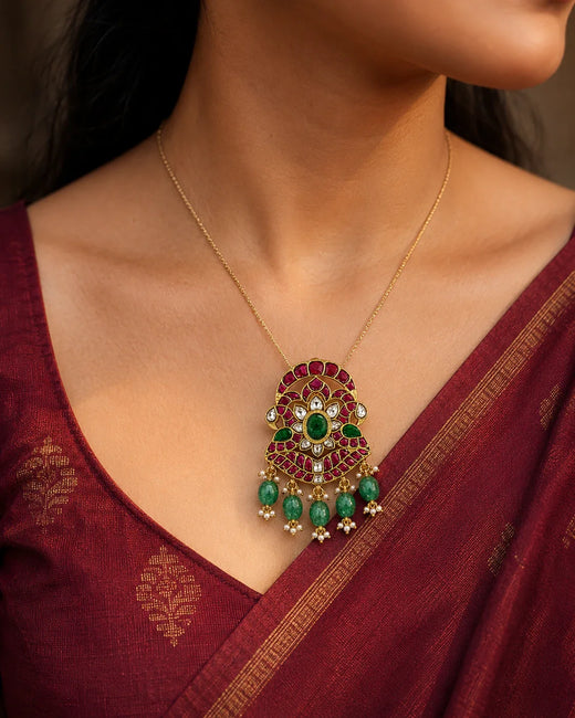 Model wearing the FeelOri Iruttai Mayil Padmam twin peacock lotus pendant with a maroon silk saree
