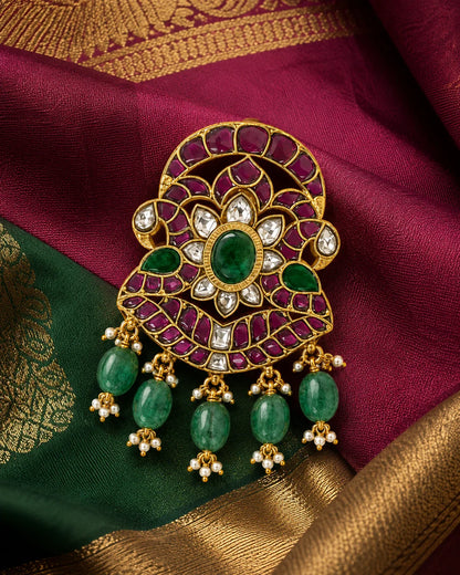 Iruttai Mayil Padmam Jadau Kundan pendant styled on maroon and green silk fabric