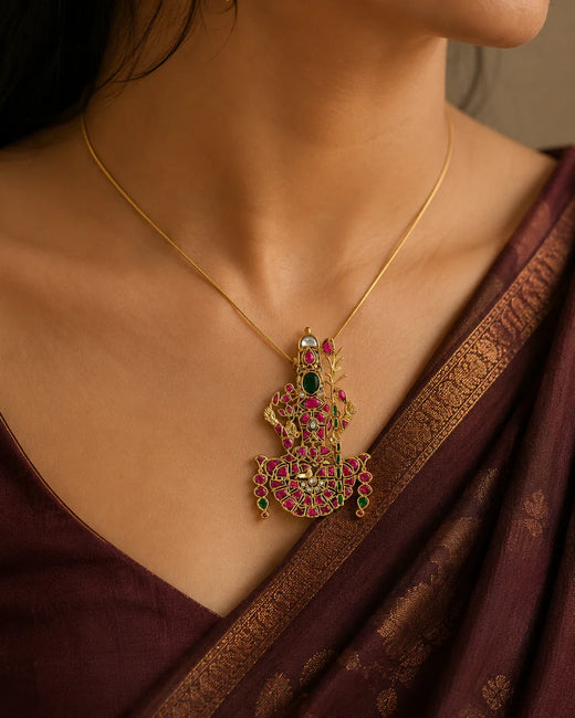 Model wearing the FeelOri Lalitha Tripurasundari Jadau Kundan temple pendant with a maroon silk saree