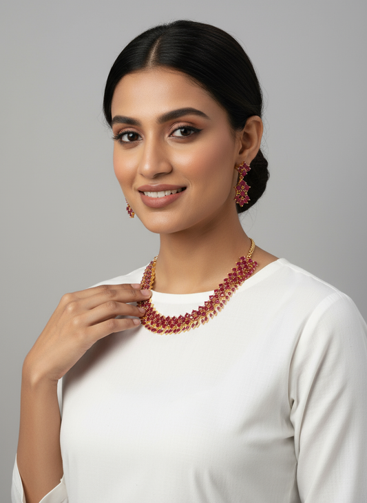 FeelOri Gold Plated Ruby Necklace Set - Elegant model wearing festive ruby petal cluster set with white top.