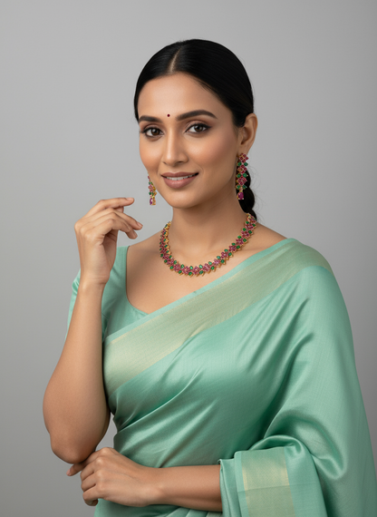 FeelOri Gold Plated Ruby Emerald Leaf Strand Jewelry Set - Model wearing vibrant set with elegant light green saree.