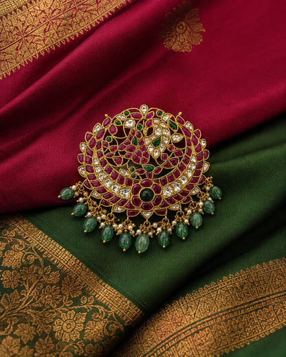 Manga Chandbali Jadau Kundan peacock pendant styled on maroon and green silk fabric