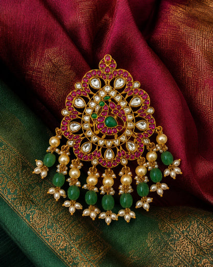 Mayur Mandala Jadau Kundan peacock pendant styled on green and magenta silk fabric