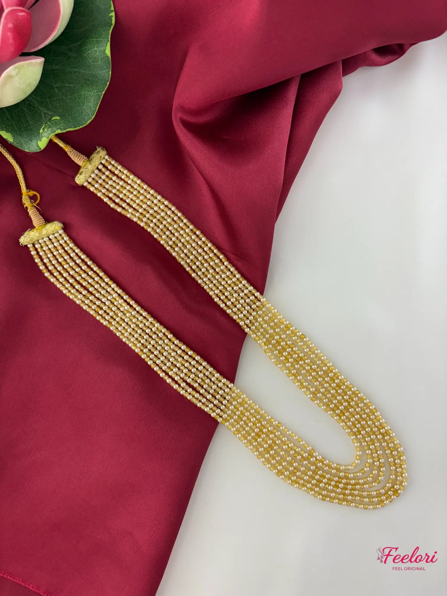 FeelOri Mother of Pearls & CZ Long Necklace - Main view showcasing the seven graded strands and Dori closure on a vibrant background.