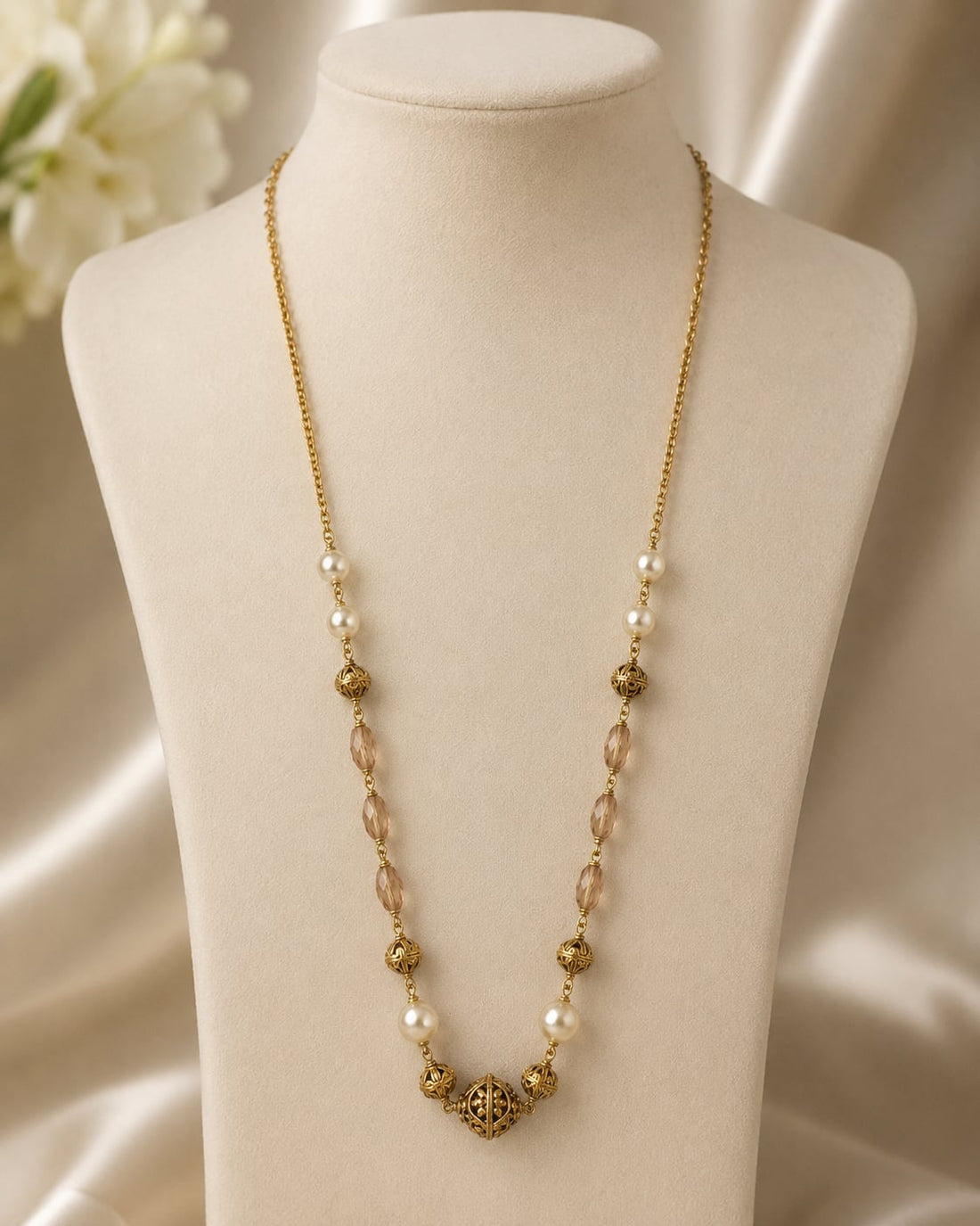 FeelOri Peach Faceted Bead and Pearl-Look Necklace on a necklace display