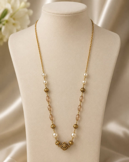 FeelOri Peach Faceted Bead and Pearl-Look Necklace on a necklace display