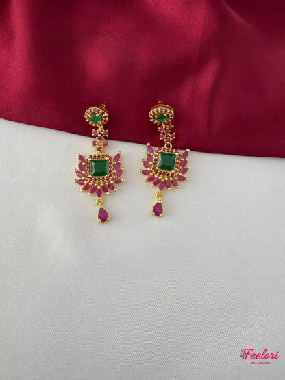 FeelOri Gold Plated Ruby Emerald Earrings - Detailed view highlighting the square emerald-hued stone and dangling ruby drops.