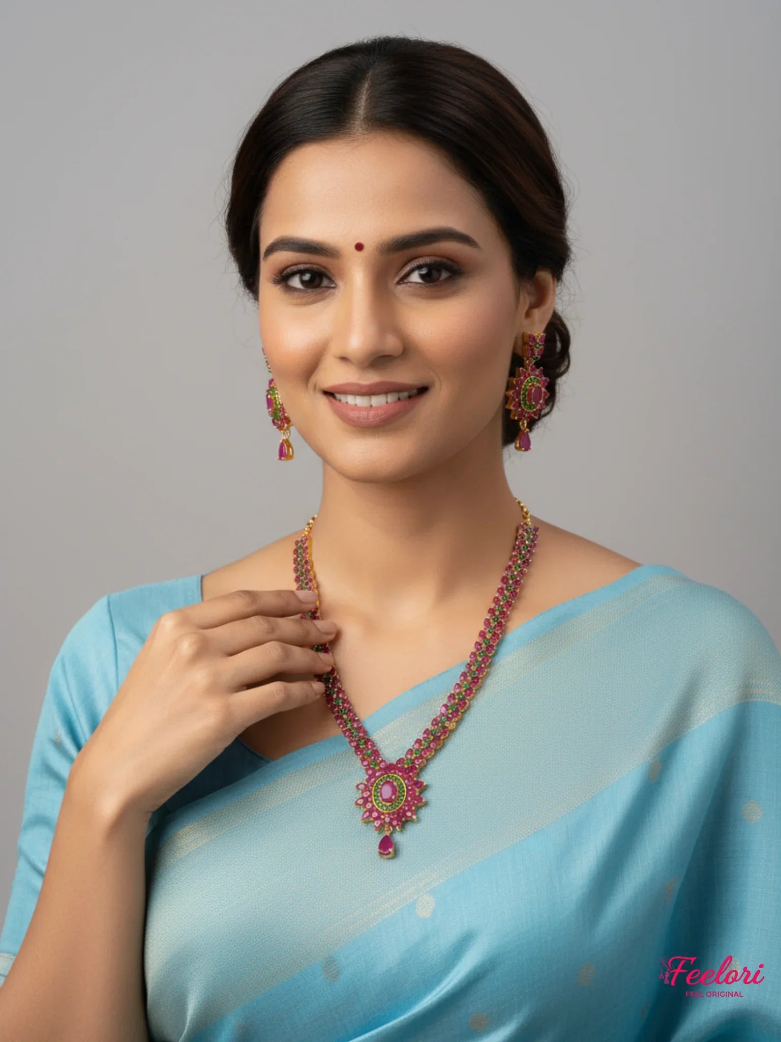 FeelOri Gold Plated Floral Ruby Emerald Necklace Set - Model wearing set with traditional blue saree.