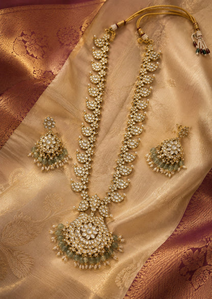 FeelOri ruby-tone and emerald-tone two-sided reversible long haram necklace set with matching earrings styled with Indian occasion wear