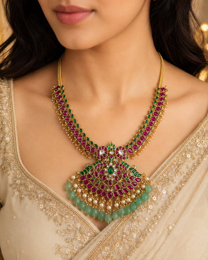 FeelOri ruby green peacock motif jadau kundan necklace with large pendant styled on a model