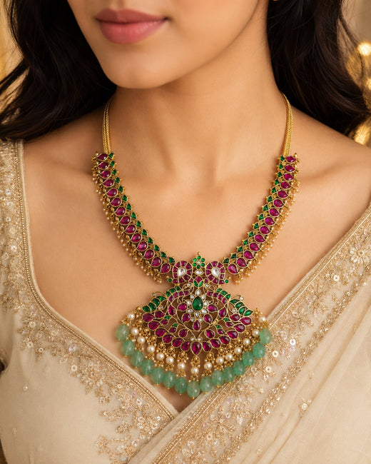 FeelOri ruby green peacock motif jadau kundan necklace with large pendant styled on a model