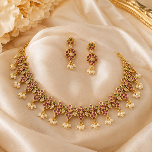 FeelOri ruby and emerald necklace set with matching earrings on jewellery display