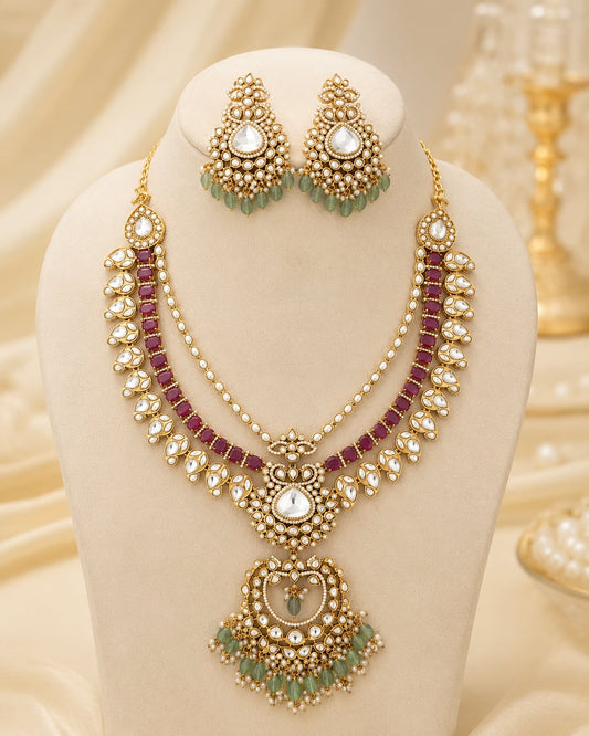 FeelOri ruby and emerald necklace set with matching earrings on jewellery display