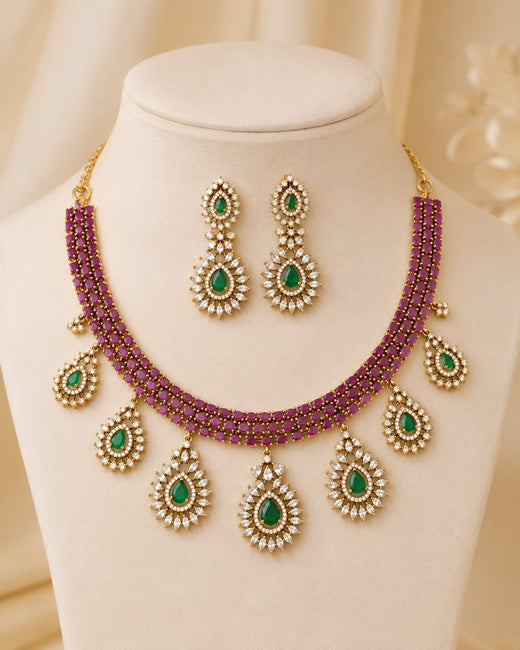 FeelOri ruby and emerald necklace set with matching earrings on jewellery display