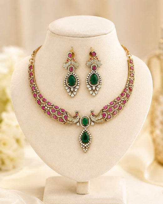 FeelOri ruby and emerald necklace set with matching earrings on jewellery display