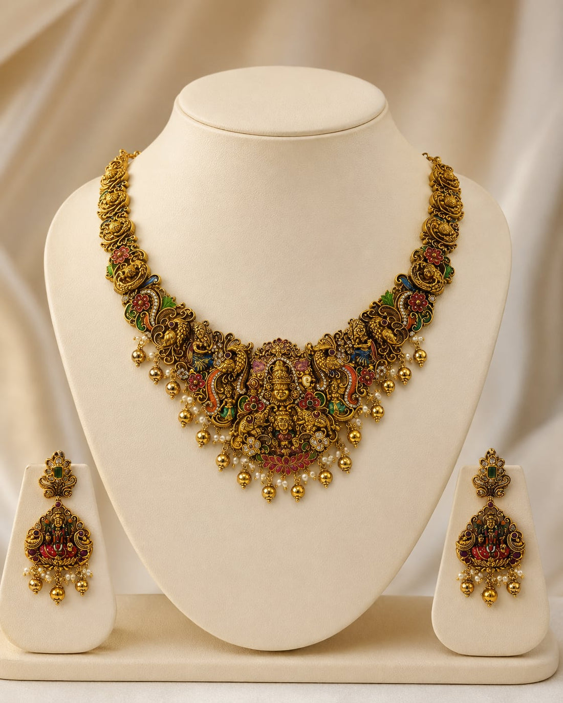 FeelOri ruby and emerald necklace set with matching earrings on jewellery display