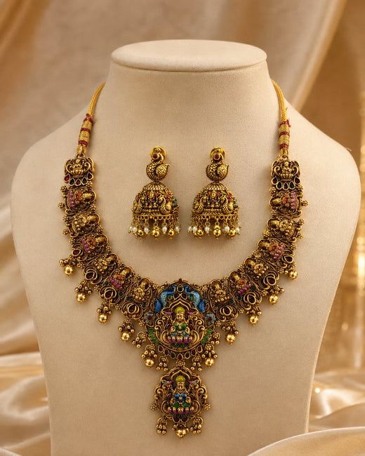 FeelOri ruby and emerald necklace set with matching earrings on jewellery display
