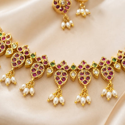 FeelOri ruby-tone and emerald-tone necklace set with matching earrings styled with saree fabric for Indian occasion wear