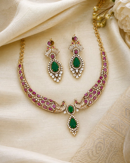 FeelOri ruby-tone and emerald-tone necklace set with matching earrings styled with saree fabric for Indian occasion wear
