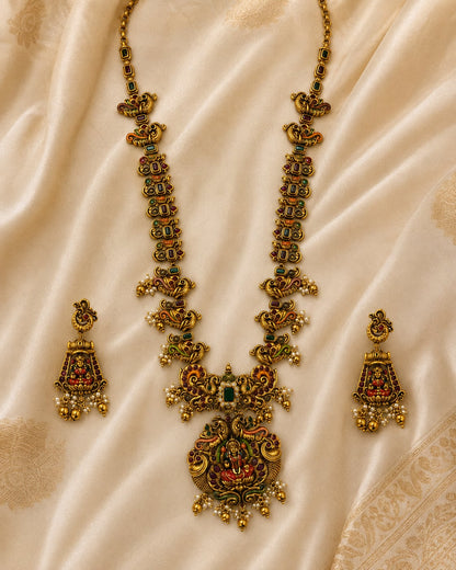 FeelOri ruby and emerald necklace set with matching earrings styled with saree fabric for Indian occasion wear