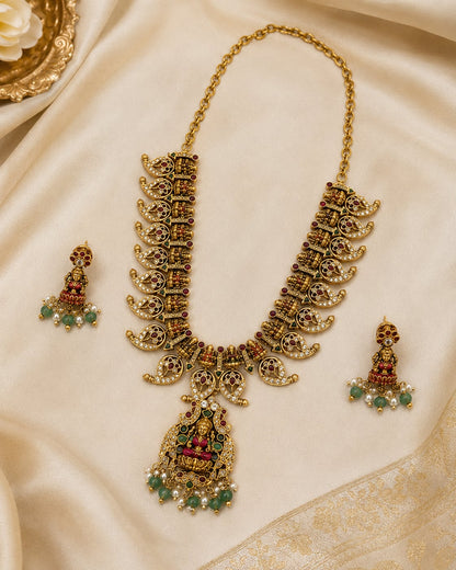 FeelOri ruby and emerald necklace set with matching earrings styled with saree fabric for Indian occasion wear