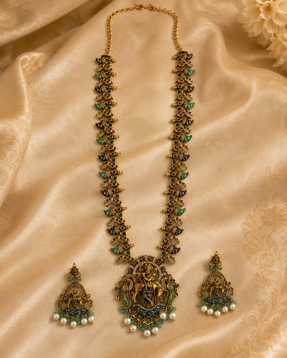 FeelOri ruby and emerald necklace set with matching earrings styled with saree fabric for Indian occasion wear