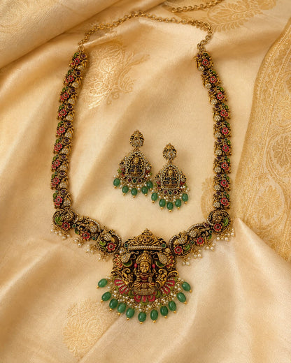 FeelOri ruby and emerald necklace set with matching earrings styled with saree fabric for Indian occasion wear