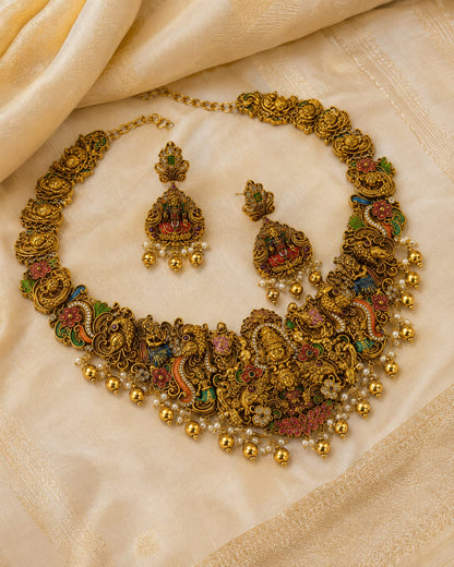 FeelOri ruby and emerald necklace set with matching earrings styled with saree fabric for Indian occasion wear