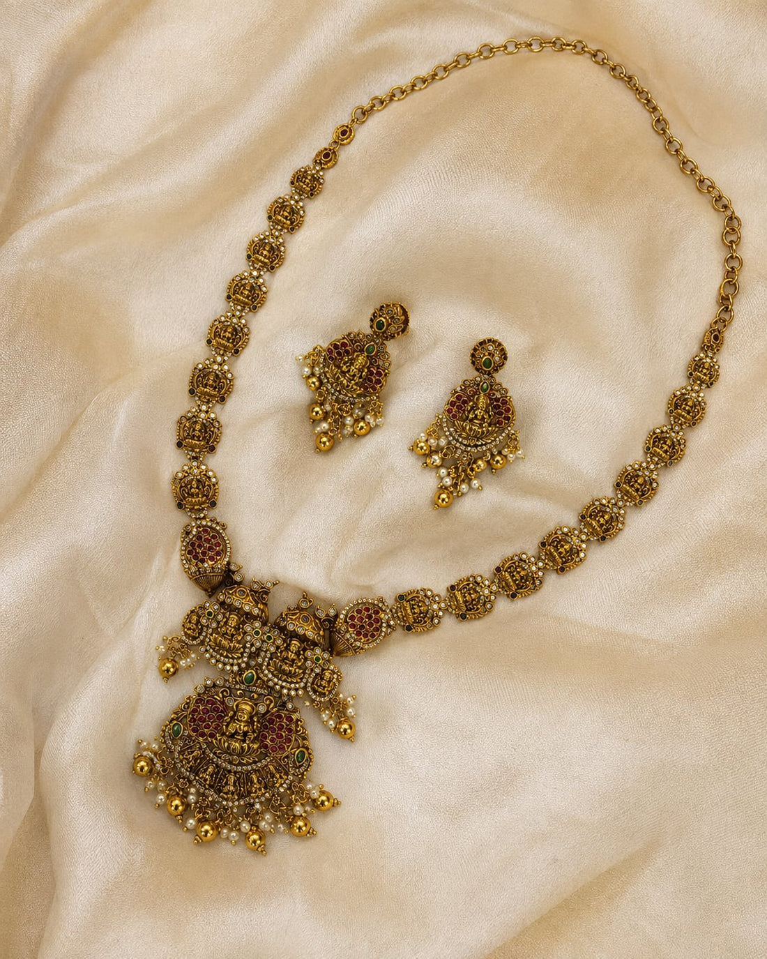 FeelOri ruby and emerald necklace set with matching earrings styled with saree fabric for Indian occasion wear