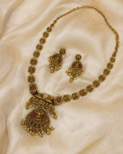 FeelOri ruby and emerald necklace set with matching earrings styled with saree fabric for Indian occasion wear