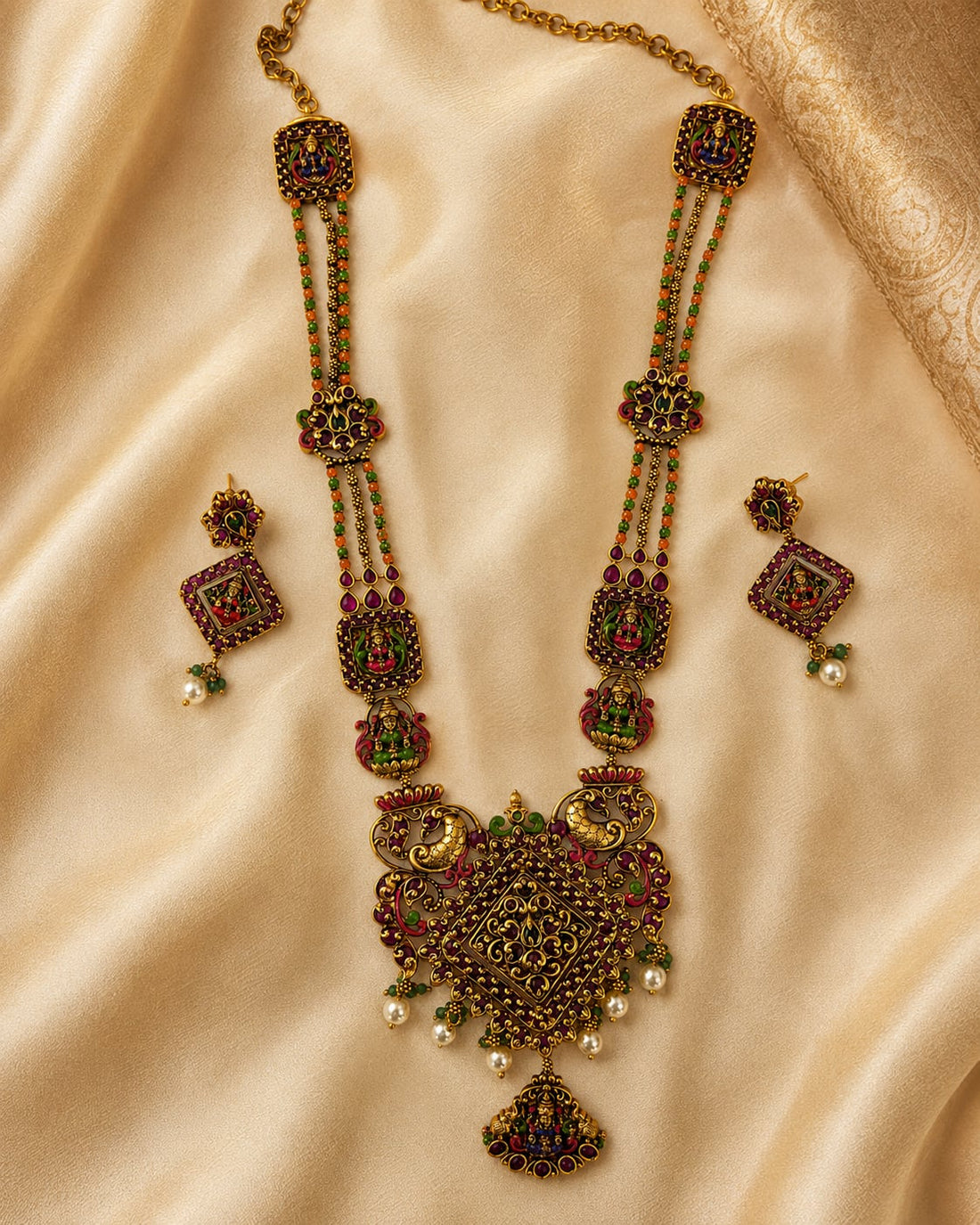 FeelOri ruby and emerald necklace set with matching earrings styled with saree fabric for Indian occasion wear