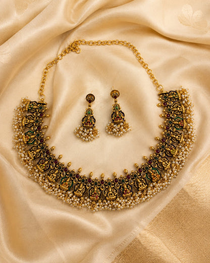 FeelOri ruby and emerald necklace set with matching earrings styled with saree fabric for Indian occasion wear