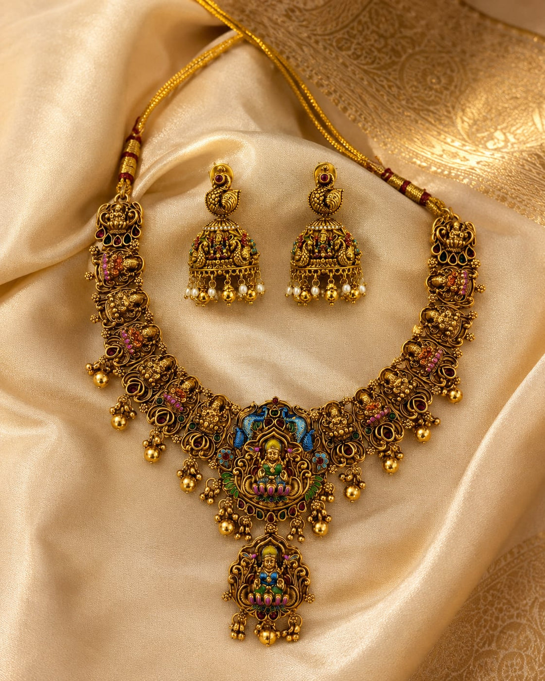 FeelOri ruby and emerald necklace set with matching earrings styled with saree fabric for Indian occasion wear
