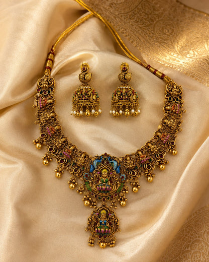 FeelOri ruby and emerald necklace set with matching earrings styled with saree fabric for Indian occasion wear