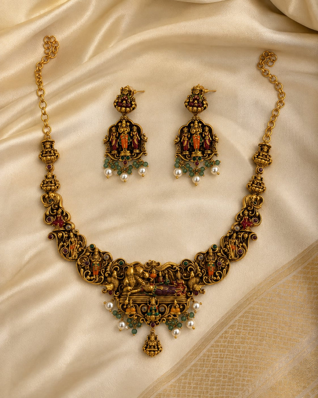 FeelOri ruby and emerald necklace set with matching earrings styled with saree fabric for Indian occasion wear