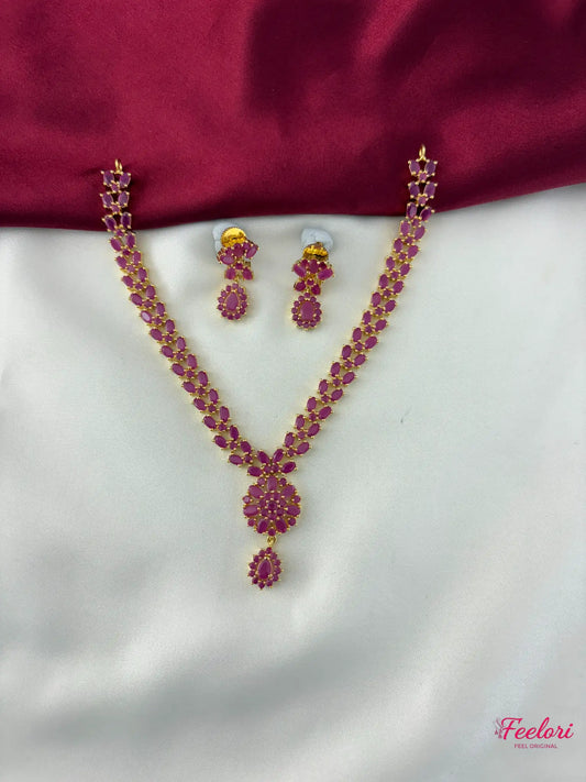 FeelOri Gold Plated Droplet Necklace Set - Front view showcasing the central floral pendant and matching earrings with rich ruby-hued stones.
