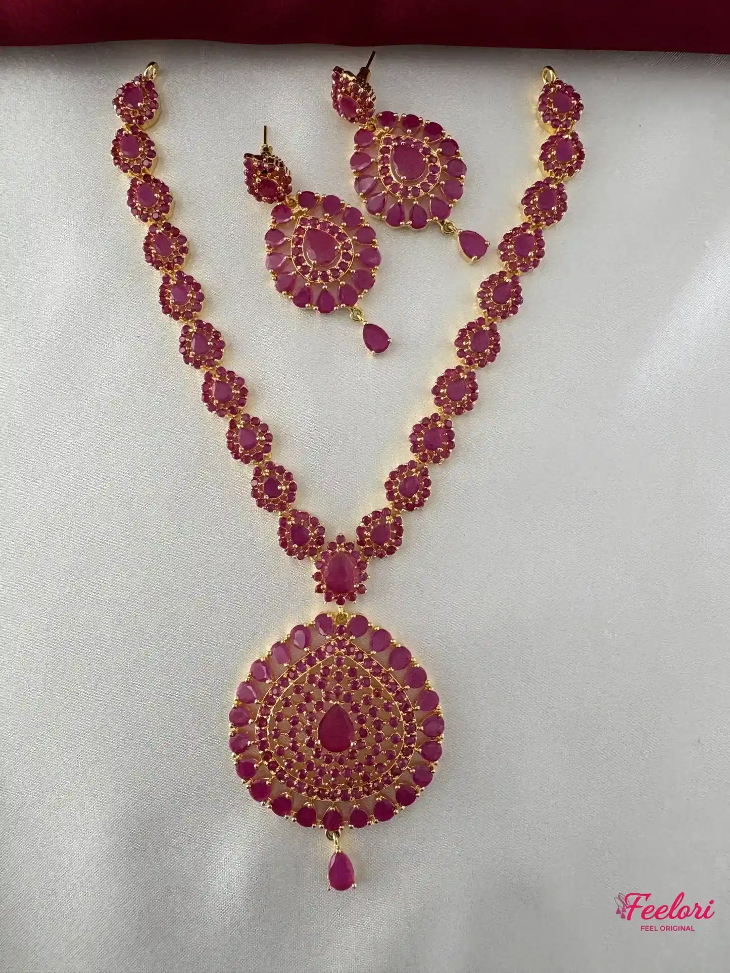 FeelOri Gold Plated Ruby Kundan Necklace & Earring Set - Front view showcasing the ornate tear-drop pendant and matching floral earrings.