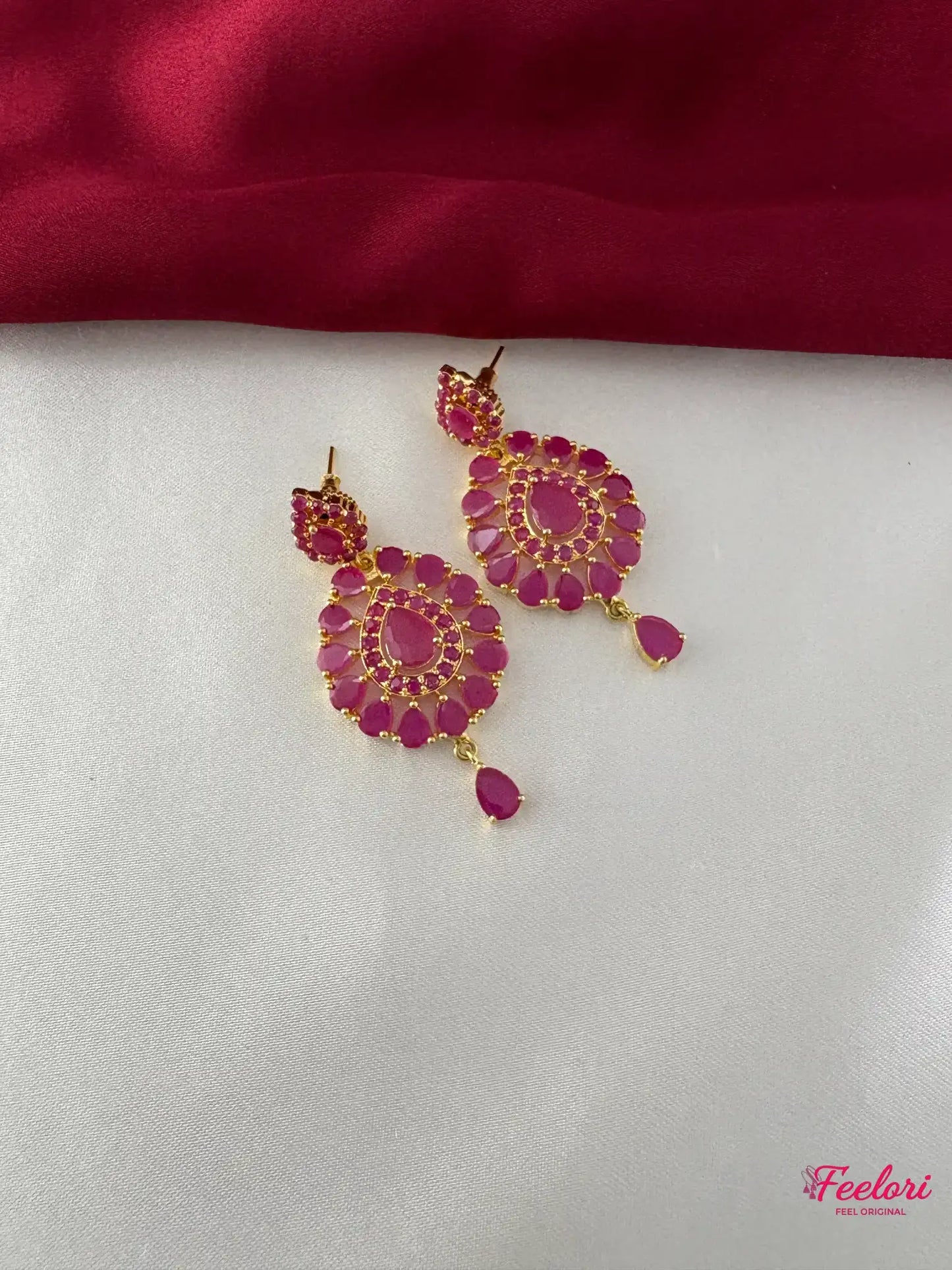 FeelOri Gold Plated Ruby Kundan Earrings - Detailed view highlighting the intricate flower-like design with genuine ruby-hued stones and a delicate droplet.
