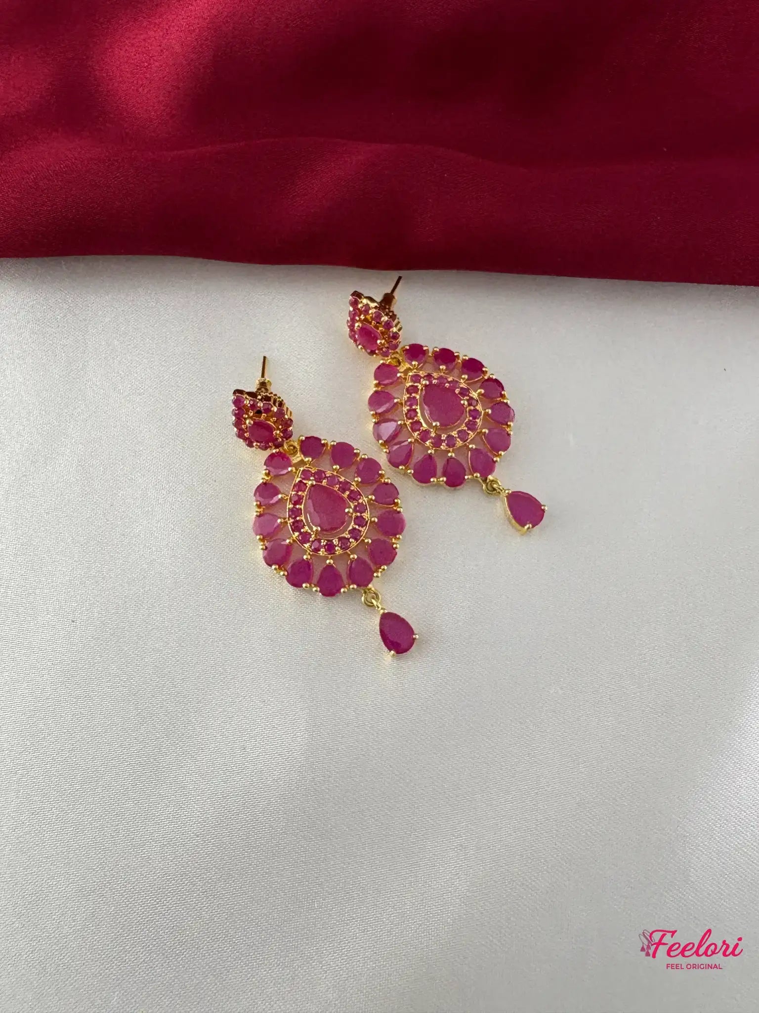 FeelOri Gold Plated Ruby Kundan Earrings - Detailed view highlighting the intricate flower-like design with Ruby-Tone CZ-hued stones and a delicate droplet.