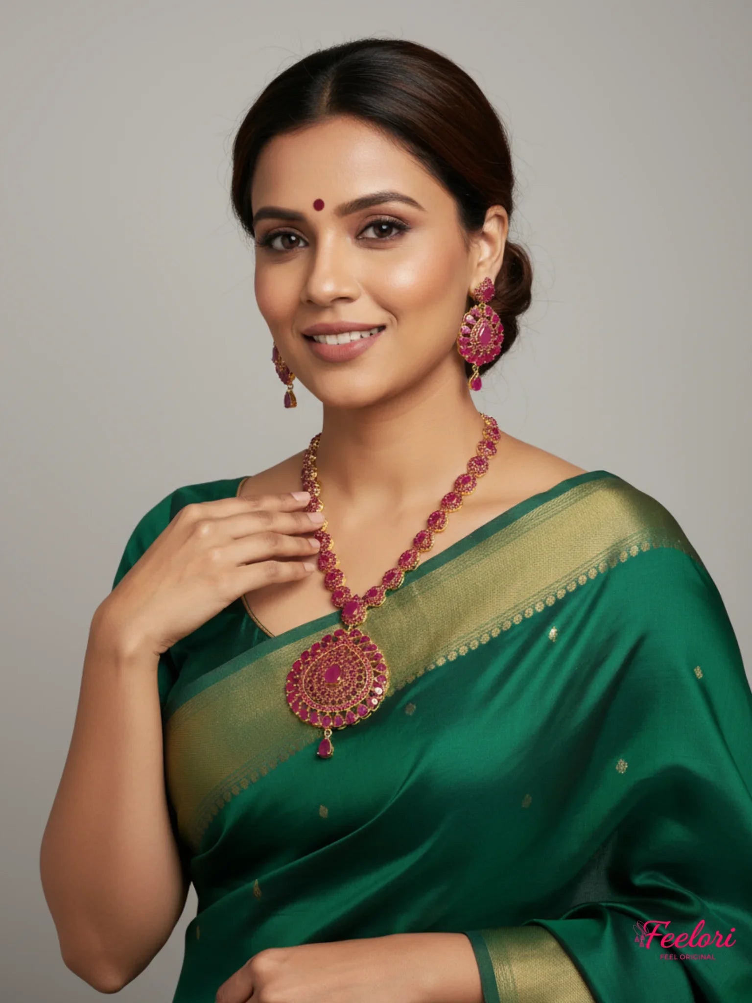 FeelOri Gold Plated Ruby Necklace & Earring Set - Model wearing set with green saree, smiling.