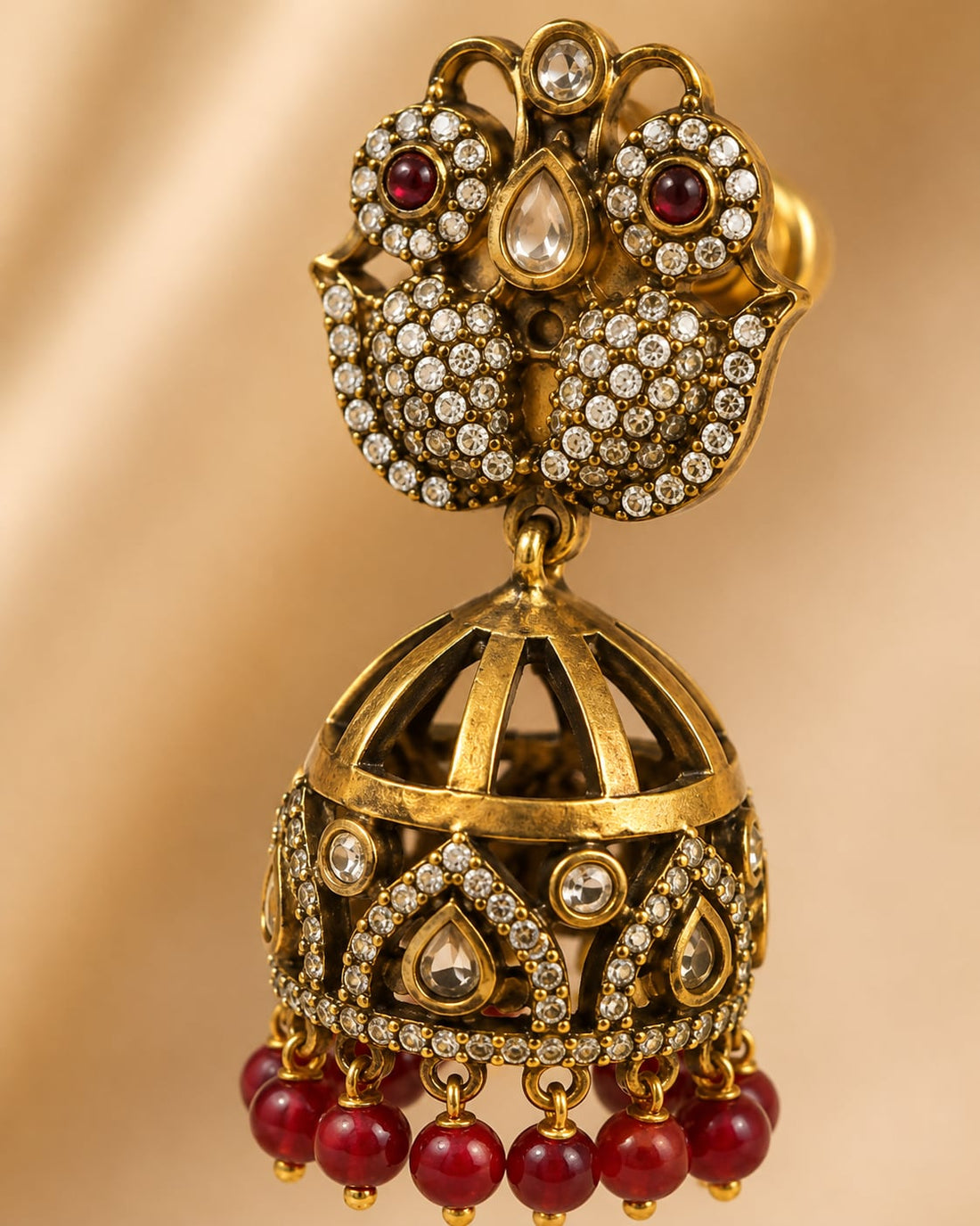 FeelOri ruby jhumka earrings stone setting, ear-chain or earring construction, and gold-polished finish detail
